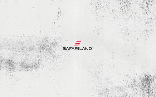 Safariland logo on a white background with black speckles