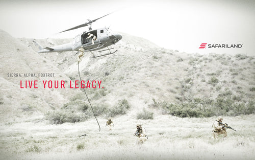 Helicopter dropping soldiers  in a grassy landscape with 'Safariland' branding.