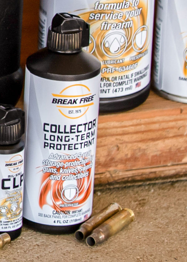 Break Free Collector Long-Term Protectant bottle with ammunition on a wooden surface