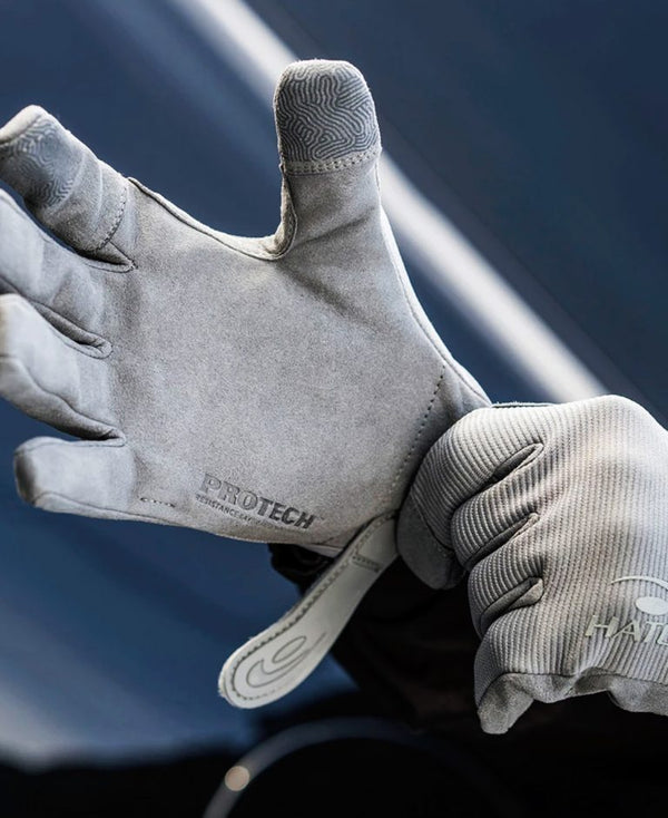 Gray gloves with 'ProTech' branding on a dark background