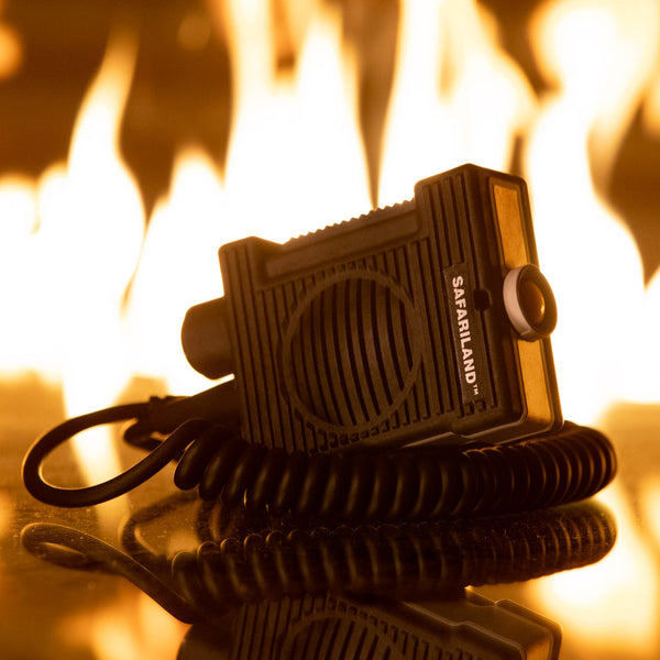 Safariland device with coiled cable on a reflective surface with flames in the background